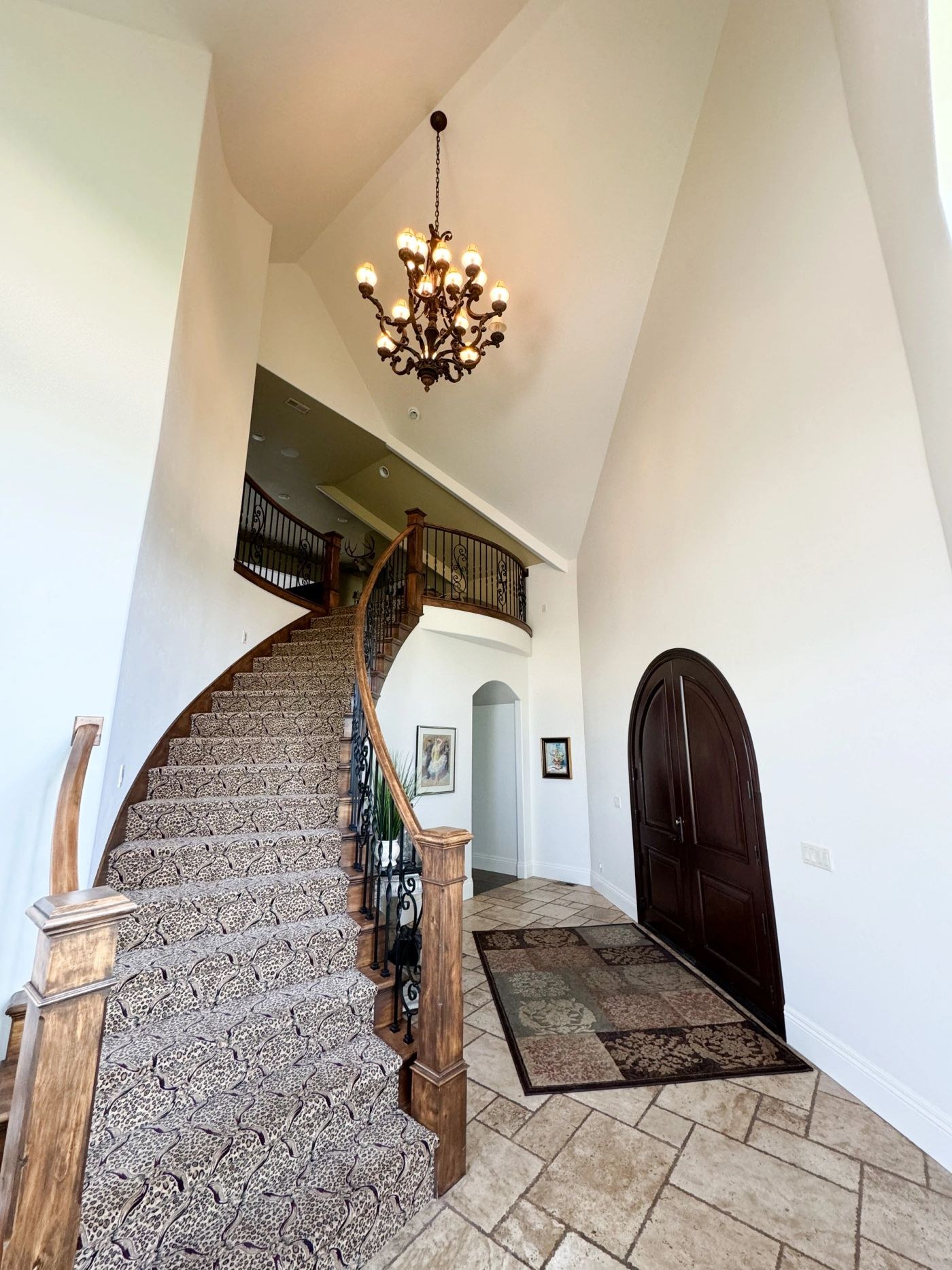 Finished entryway and staircase painted by Muñoz Painting and Drywall